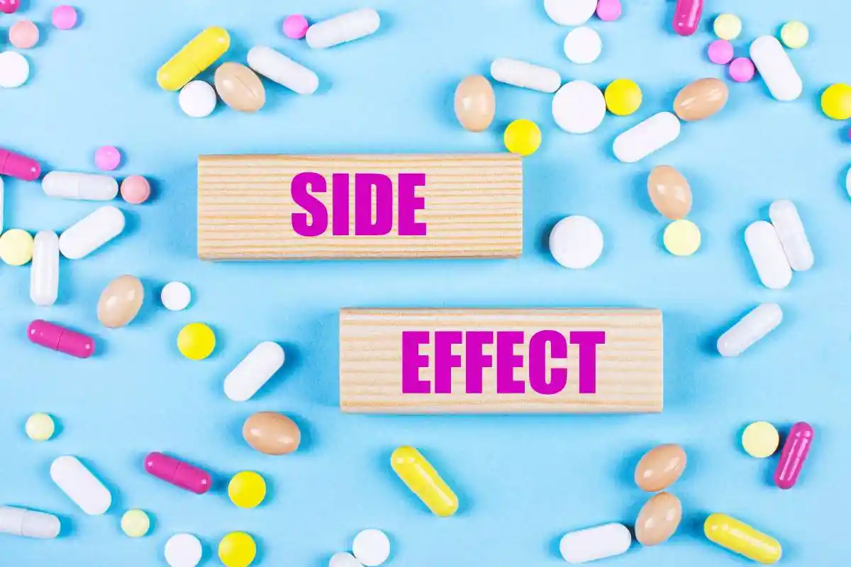 On a light blue background, multi-colored pills and wooden blocks with the text SIDE EFFECT. Pharmaceutics. Medical concept.
used in Compensation For a Pharmacy Medication Error