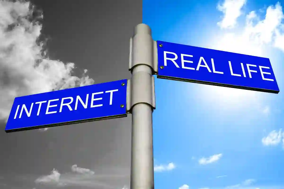 Internet Addiction Concept - Street signs showing the directions to INTERNET and REAL LIFE