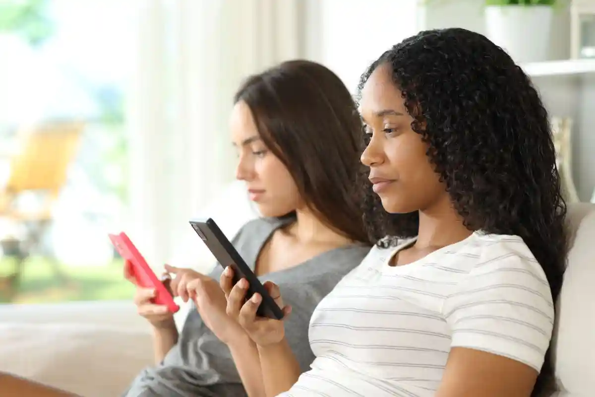 Profile of two serious friends or roommates ignoring each other using their phones at home
in Social Media Addiction Lawsuit Lawyer in Nashville